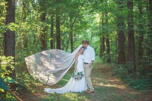 bride and groom in pines